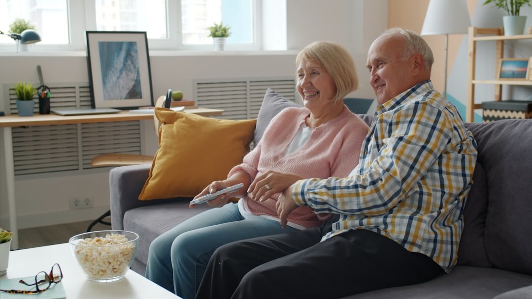 smiling couple watching old ad