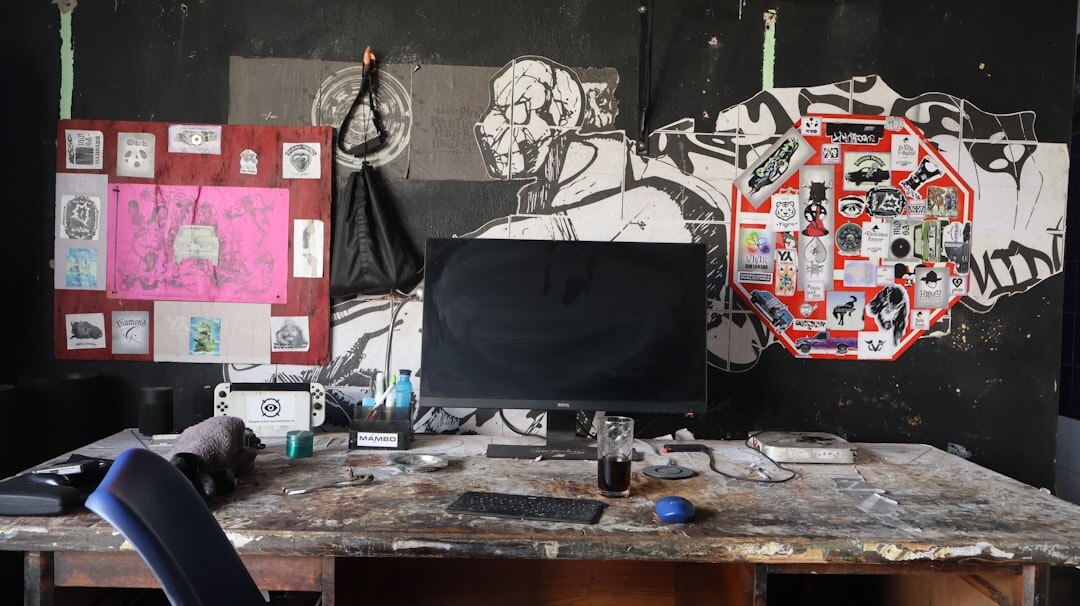 Graphic design studio desk with posters, mood boards and design tools